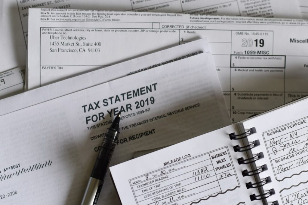 Homeowner reviewing a property tax statement at a kitchen table with documents and a calculator nearby.